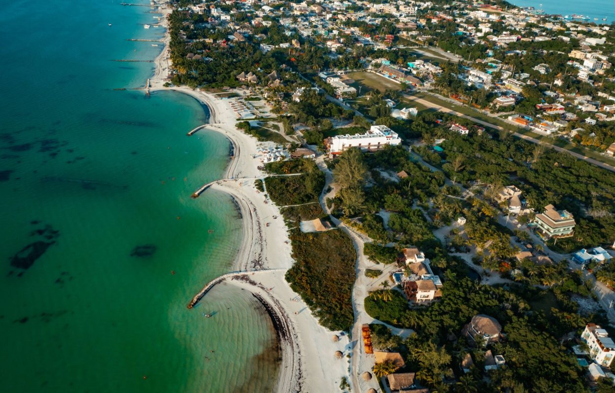 An aerial view of the coastline of the Isla Holbox Island on a bright sunny day